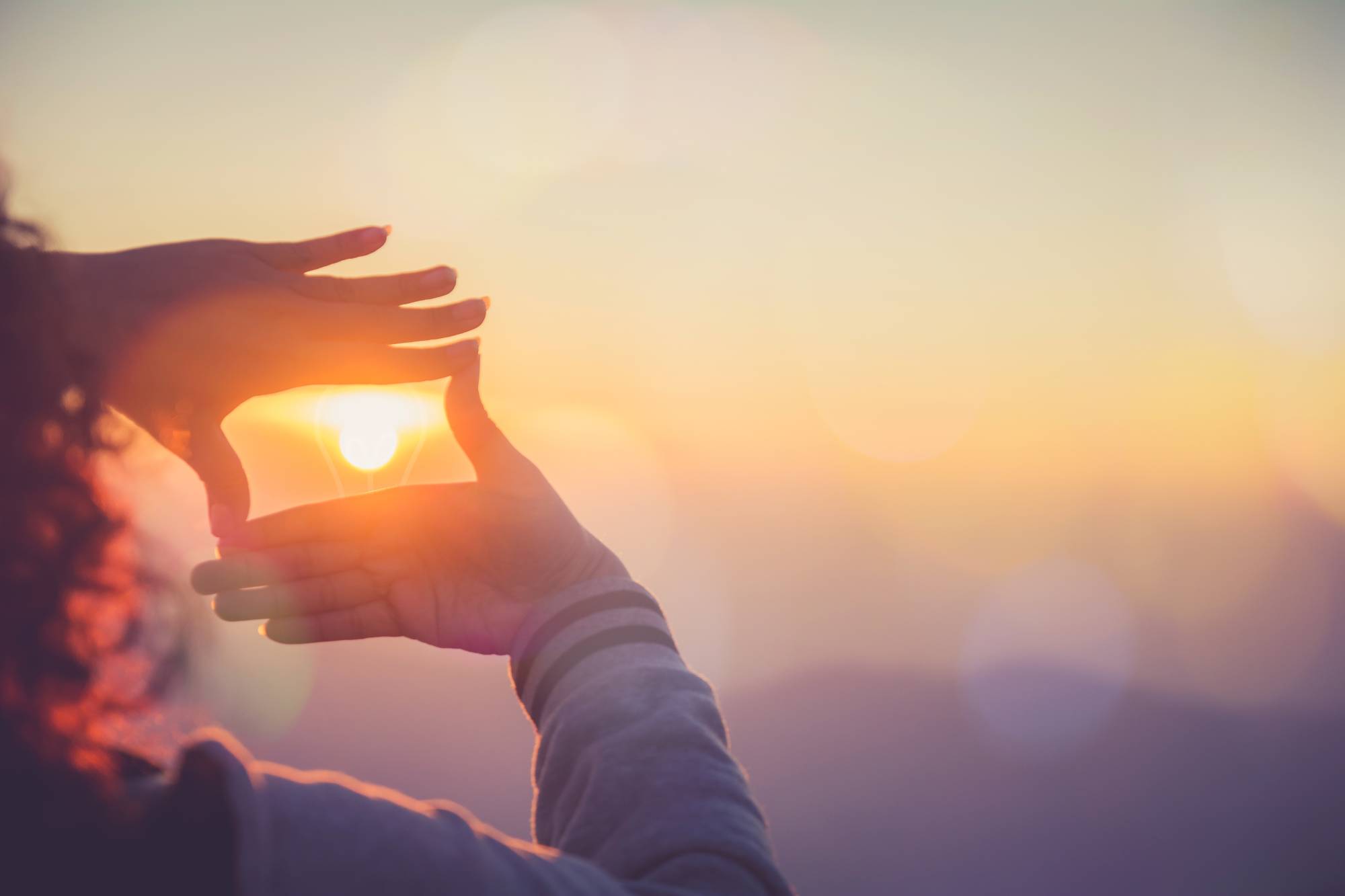 Seeing sunset through hand window