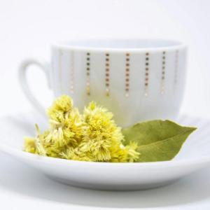 teacup and yellow flower on saucer