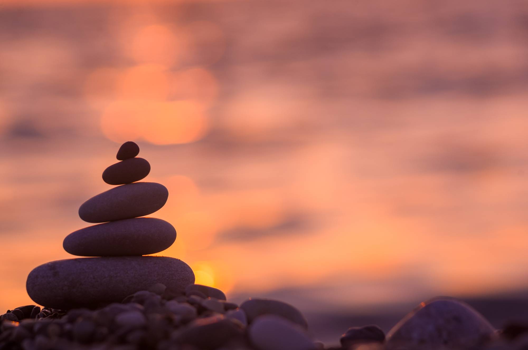 Rocks stacked against a sunset